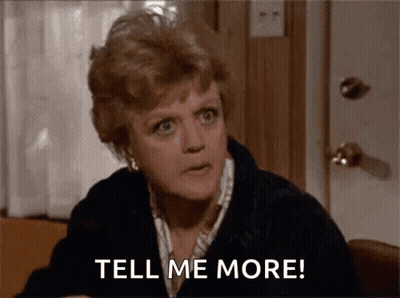 A Woman Is Sitting At A Table Talking To Someone And Says `` Tell Me More '' . GIF