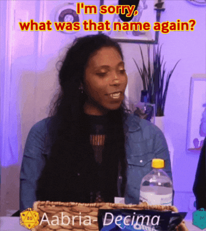 A Woman Is Sitting At A Table With A Bottle Of Water And A Box Of Aaoria-Decimo Cookies GIF