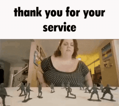 A Woman Is Sitting At A Table With A Bunch Of Toy Soldiers In Front Of Her . GIF