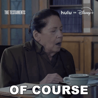 A Woman Is Sitting At A Table With A Cup Of Coffee And The Words Of Course Written On The Bottom GIF