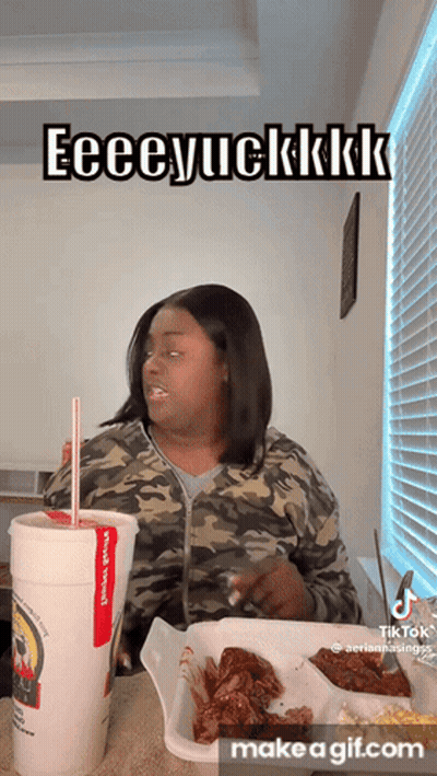 A Woman Is Sitting At A Table With A Cup Of Soda And A Tray Of Food And Says Eeeeyuckkkk GIF