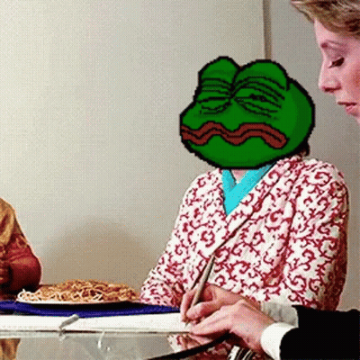 A Woman Is Sitting At A Table With A Frog On Her Head GIF