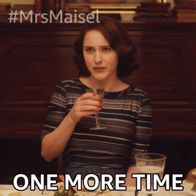 A Woman Is Sitting At A Table With A Glass Of Wine And The Words One More Time Below Her GIF