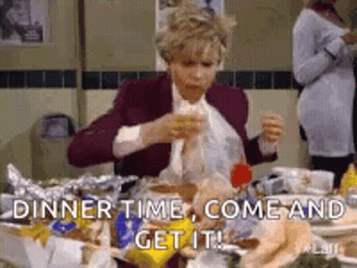 A Woman Is Sitting At A Table With A Lot Of Food And Eating . GIF