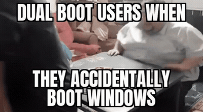 A Woman Is Sitting At A Table With A Meme On It That Says `` Dual Boot Users When They Accidentally Boot Windows '' . GIF