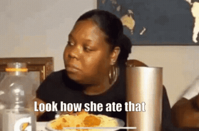 A Woman Is Sitting At A Table With A Plate Of Food And A Bottle Of Gatorade . GIF