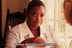 A Woman Is Sitting At A Table With A Plate Of Food And Says Minnie Don 'T Burn Chicken GIF