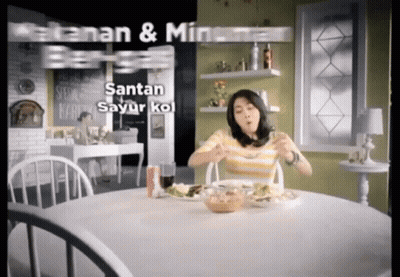 A Woman Is Sitting At A Table With A Plate Of Food And The Words Santan Sayur Kol On The Bottom GIF