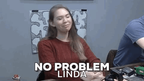 A Woman Is Sitting At A Table With Her Eyes Closed And The Words `` No Problem Linda '' Written On Her Face . GIF