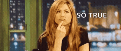 A Woman Is Sitting At A Table With Her Finger On Her Chin And The Words `` So True '' Written Above Her . GIF