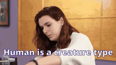 A Woman Is Sitting At A Table With The Words Human Is A Creature Type Written On The Bottom GIF