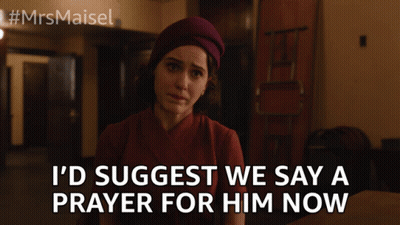 A Woman Is Sitting At A Table With The Words I 'D Suggest We Say A Prayer For Him Now GIF