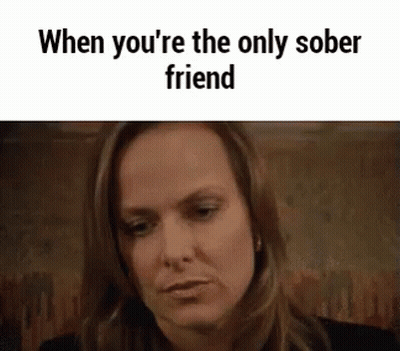 A Woman Is Sitting At A Table With The Words `` When You 'Re The Only Sober Friend '' . GIF