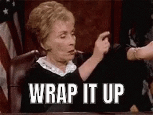 A Woman Is Sitting At A Table With The Words `` Wrap It Up '' Written On Her Face . GIF
