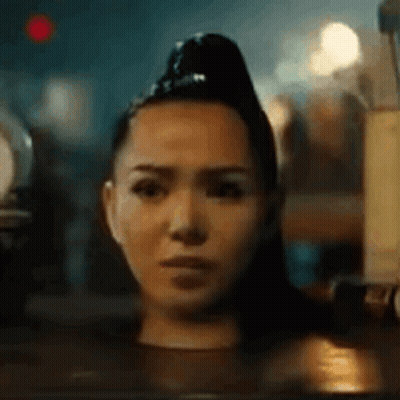 A Woman Is Sitting In A Bathtub With Her Head In The Water And Making A Funny Face . GIF
