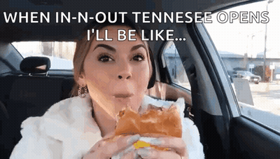A Woman Is Sitting In A Car Eating A Sandwich With The Caption When In-N-Out Tennessee Opens GIF