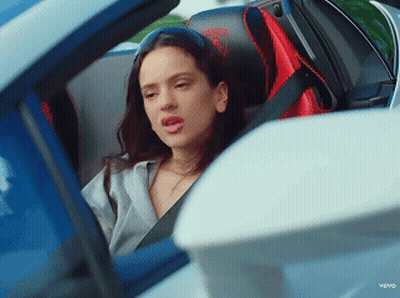 A Woman Is Sitting In A Car With A Seat Belt On GIF