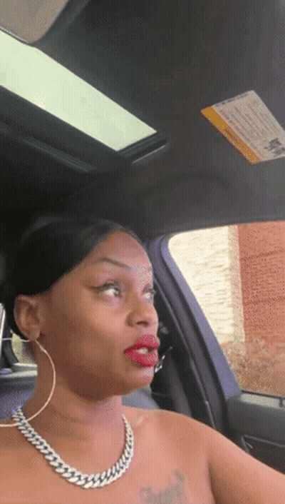 A Woman Is Sitting In A Car With A Warning Sign On The Sunroof GIF
