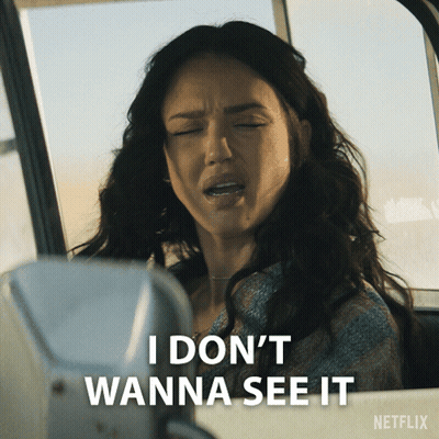 A Woman Is Sitting In A Car With Her Eyes Closed And Says " I Don 'T Wanna See It " GIF