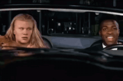A Woman Is Sitting In A Car With Her Mouth Open . GIF