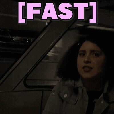 A Woman Is Sitting In A Car With The Words Fast Behind Her GIF