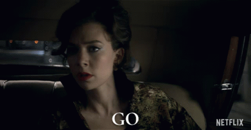 A Woman Is Sitting In A Car With The Words Go Written On The Bottom GIF