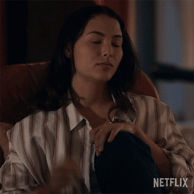 A Woman Is Sitting In A Chair And Says Do You Promise To Behave Netflix GIF