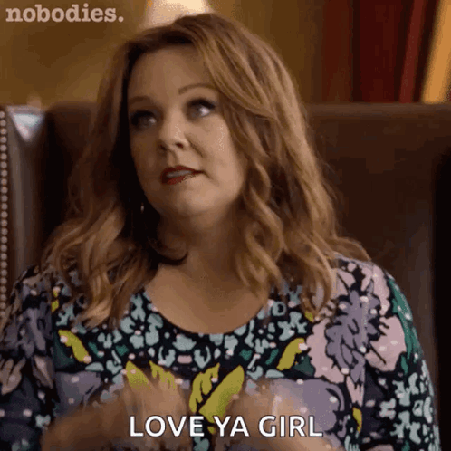 A Woman Is Sitting In A Chair And Says Love Ya Girl GIF