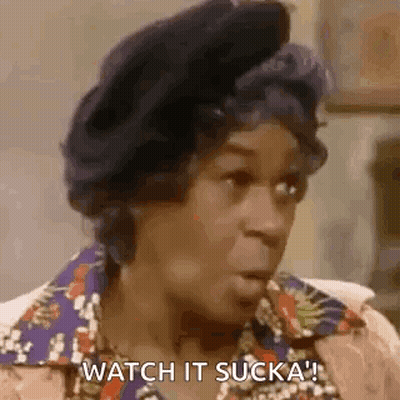 A Woman Is Sitting In A Chair And Talking To Another Woman . GIF