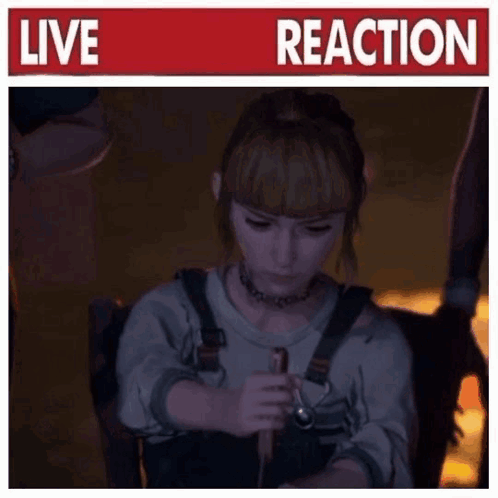 A Woman Is Sitting In A Chair Holding A Stick In Front Of A Sign That Says Live Reaction GIF