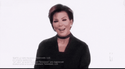 A Woman Is Sitting In A Chair Holding A Tissue To Her Face . GIF