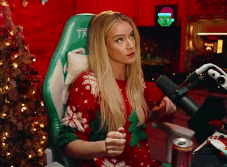A Woman Is Sitting In A Chair In Front Of A Microphone . GIF