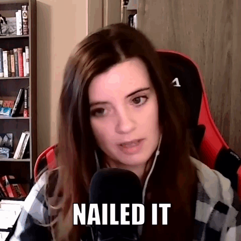 A Woman Is Sitting In A Chair In Front Of A Microphone With The Words Nailed It Written On Her Face . GIF