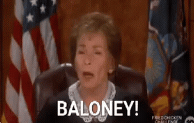 A Woman Is Sitting In A Chair In Front Of An American Flag And Saying Baloney . GIF