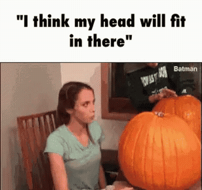 A Woman Is Sitting In A Chair Next To A Pumpkin . GIF