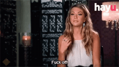 A Woman Is Sitting In A Chair Saying Fuck Off GIF