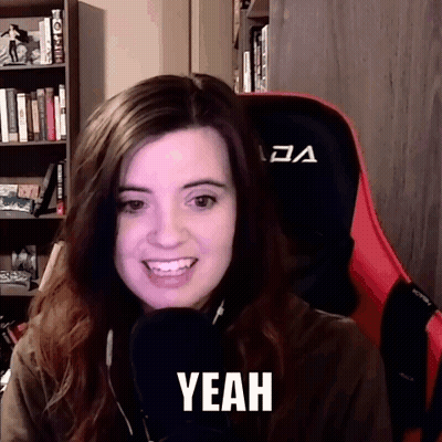 A Woman Is Sitting In A Chair With A Microphone And The Word Yeah Is On Her Face . GIF
