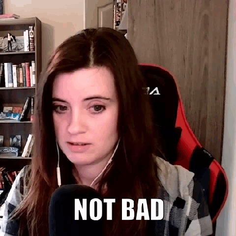 A Woman Is Sitting In A Chair With A Microphone And The Words `` Not Bad '' On Her Face . GIF