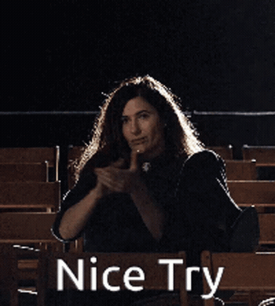 A Woman Is Sitting In A Chair With Her Arms In The Air And The Words Nice Try Behind Her GIF