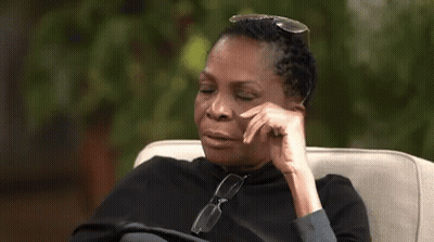A Woman Is Sitting In A Chair With Her Eyes Closed And The Word Lord Written On The Screen . GIF