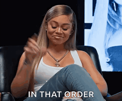 A Woman Is Sitting In A Chair With Her Legs Crossed And Says In That Order . GIF