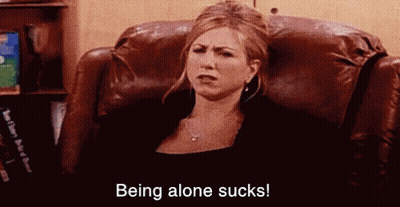 A Woman Is Sitting In A Chair With The Words `` Being Alone Sucks '' Written On The Bottom . GIF