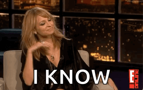 A Woman Is Sitting In A Chair With The Words `` I Know '' Written On The Screen . GIF