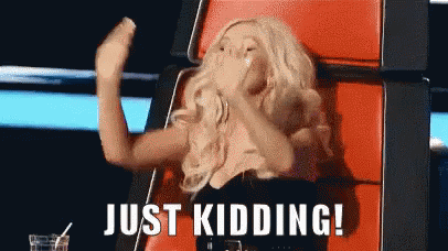 A Woman Is Sitting In A Chair With The Words Just Kidding Above Her GIF