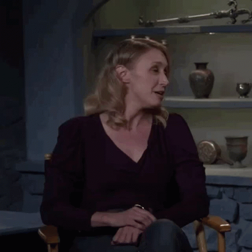 A Woman Is Sitting In A Chair With The Words Not Yet Written On Her Face GIF