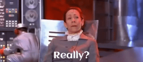 A Woman Is Sitting In A Chair With The Words Really Written On The Screen . GIF