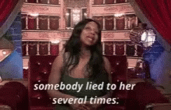 A Woman Is Sitting In A Chair With The Words `` Somebody Lied To Her Several Times '' Written On The Screen . GIF