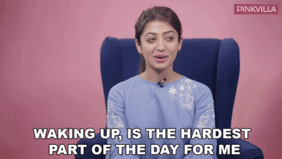 A Woman Is Sitting In A Chair With The Words Waking Up Is The Hardest Part Of The Day For Me Written Below Her GIF