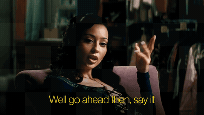A Woman Is Sitting In A Chair With The Words Well Go Ahead Then Say It GIF