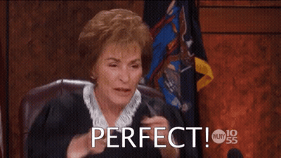 A Woman Is Sitting In A Courtroom With Her Hands In The Air And The Words Perfect Above Her GIF